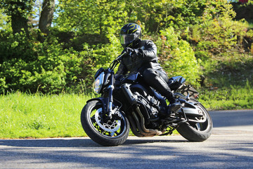 Sporting motorcyclist on a winding country road