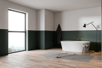 Green and white bathroom corner with tub
