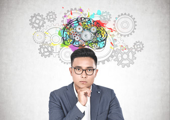 Asian businessman in glasses, gear brain
