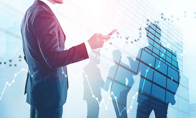 Man with phone and team, forex graphs