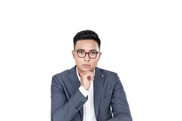 Pensive Asian businessman in glasses, isolated