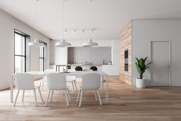 White and wooden kitchen with bar and table