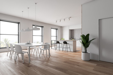 White and wooden kitchen corner with bar and table