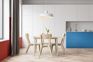 White and red kitchen with table and counters