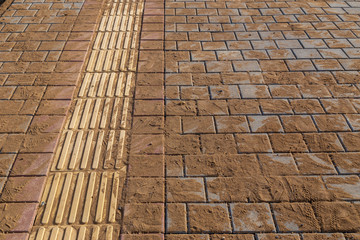 Fresh made pedestrain pavement with accessibility feature of road for people with blind disability.