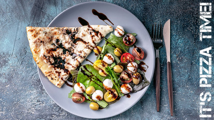 Pizza and salad with greens, mozzarella, balsamic sauce. Traditional Mediterranean cuisine