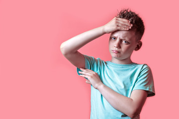 a boy in a light t-shirt got sick and feels bad on a colored background