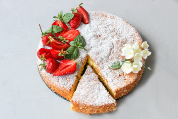 Fototapeta na wymiar Orange cake decorated with strawberries