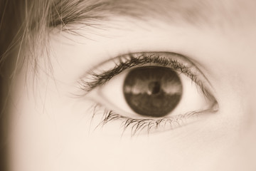 Brown eye girl, sepia macro photo
