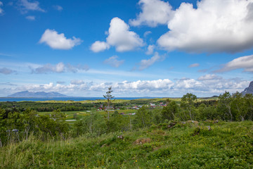 White clouds over mountains and landscape