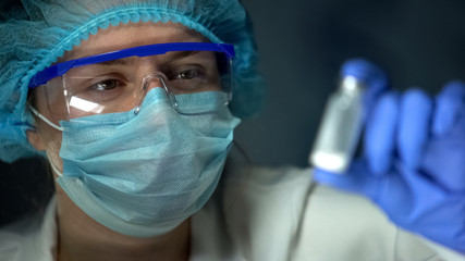 Researcher holding ampule with white powder, medication test, antibiotics