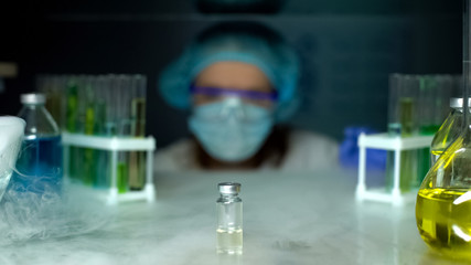 Bottle with transparent liquid in refrigerator, pharmacological researches, lab
