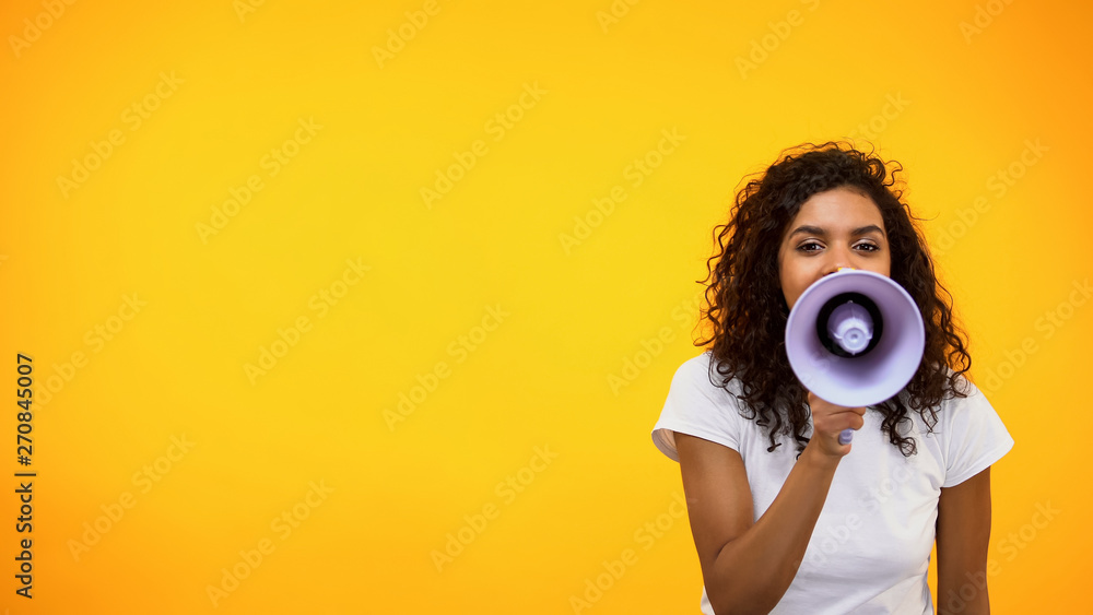 Wall mural Afro-American female shouting in megaphone, public relations, social opinion