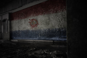 painted flag of paraguay on the dirty old wall in an abandoned ruined house