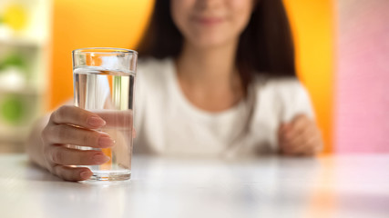 Female holding water glass, health care, body hydration, slimming and dieting