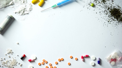 Different drugs and syringe on table, abuse and addiction concept, awareness - obrazy, fototapety, plakaty