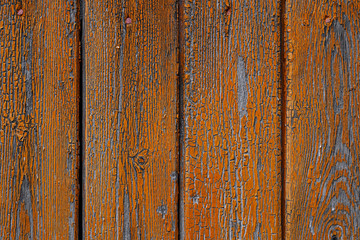 Vintage wood background with peeling orange paint