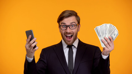 Male looking at smartphone and immediately receiving money cash back application