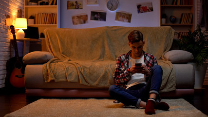 Upset teenage student having problems with live communication, chatting on phone