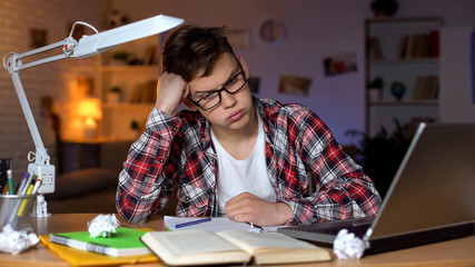 Anxious teenager student trying to solve difficult math assignment, problems
