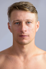 Obraz premium Portrait shot of young handsome Caucasian man shirtless isolated