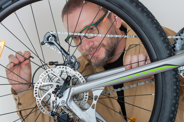 Bearded caucasian man repairing  the mtb bicycle