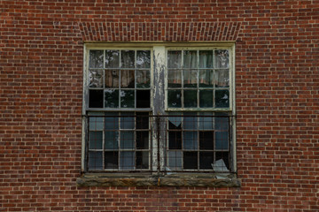 Decaying brick building smashed windows