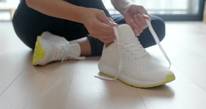 Woman wear sport shoes and prepare for running