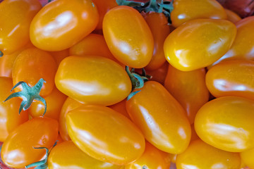 fresh cherry tomatoes top view close up, natural orange background