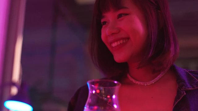 Young asian millennial woman hanging out with friend in nightclub bar, lifestyle concept