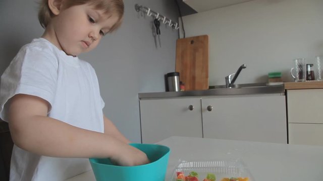 little girl gaining dried pineapples andied fruit