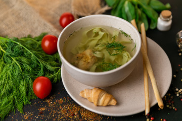 Chicken and potato chowder soup with green bell pepper and carrot in bowls. Healthy food, top view. Black background . Slow-mo.