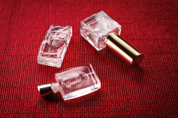 three perfumes on a red background