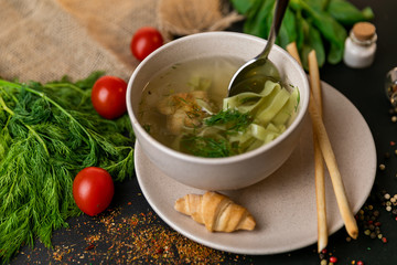 Chicken and potato chowder soup with green bell pepper and carrot in bowls. Healthy food, top view. Black background . Slow-mo.