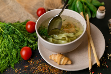 Chicken and potato chowder soup with green bell pepper and carrot in bowls. Healthy food, top view. Black background . Slow-mo.