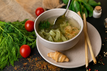 Chicken and potato chowder soup with green bell pepper and carrot in bowls. Healthy food, top view. Black background . Slow-mo.