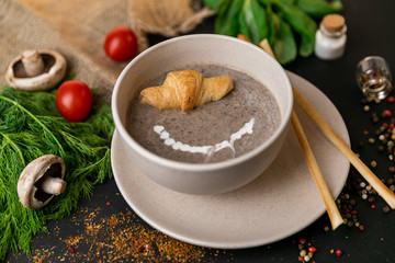 mushroom cream soup on white wooden board. top view. Healthy food, top view. Black background . Slow-mo.