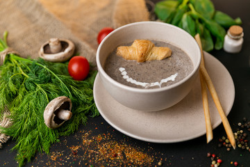 mushroom cream soup on white wooden board. top view. Healthy food, top view. Black background . Slow-mo.