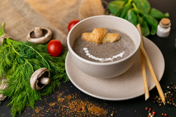 mushroom cream soup on white wooden board. top view. Healthy food, top view. Black background . Slow-mo.