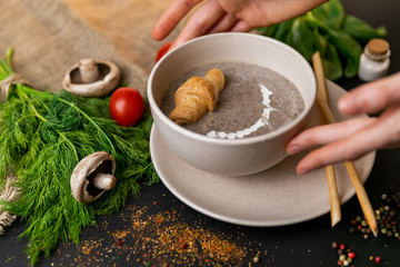 mushroom cream soup on white wooden board. top view. Healthy food, top view. Black background . Slow-mo.