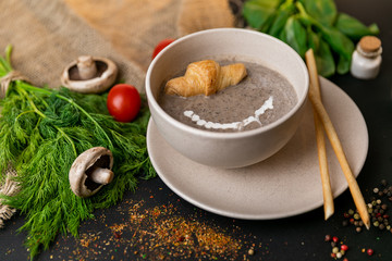 mushroom cream soup on white wooden board. top view. Healthy food, top view. Black background . Slow-mo.