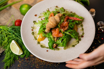 Healthy salad plate. Fresh seafood recipe. Grilled shrimps and fresh vegetable salad and egg. Grilled prawns. Healthy food. Flat lay. Top view. Black background . Slow-mo.