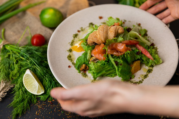 Healthy salad plate. Fresh seafood recipe. Grilled shrimps and fresh vegetable salad and egg. Grilled prawns. Healthy food. Flat lay. Top view. Black background . Slow-mo.
