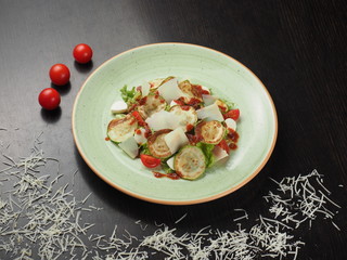 Fresh salad with grilled zucchini, cheese, lettuce and cherry tomatoes