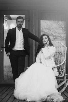 A pair of stylish newlyweds with a model look on a wedding photo shoot