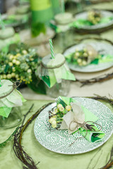 Served table at restaurant. Preparation for banquet. Restaurant table decoration for festive event. Green color