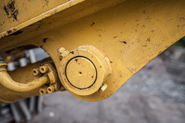Detail of the base mount of a hydraulic cylinder on an excavator.
