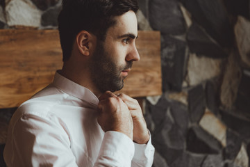 Handsome groom at wedding smiling and waiting for bride man. Happy smiling groom newlywed. Rich man at wedding day. Elegant groom in tuxedo costume. Handsome caucasian man in tuxedo.
