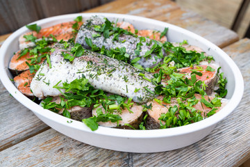 Fresh salmon cut in to chunks and marinated with spices  and fresh herbs ready for the grill