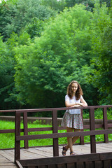 teenage girl in on a bridge in summer park